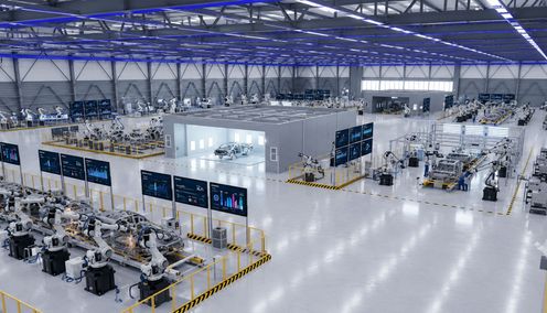 Aerial view of an automotive manufacturing plant with data overlay showing real-time monitoring metrics.