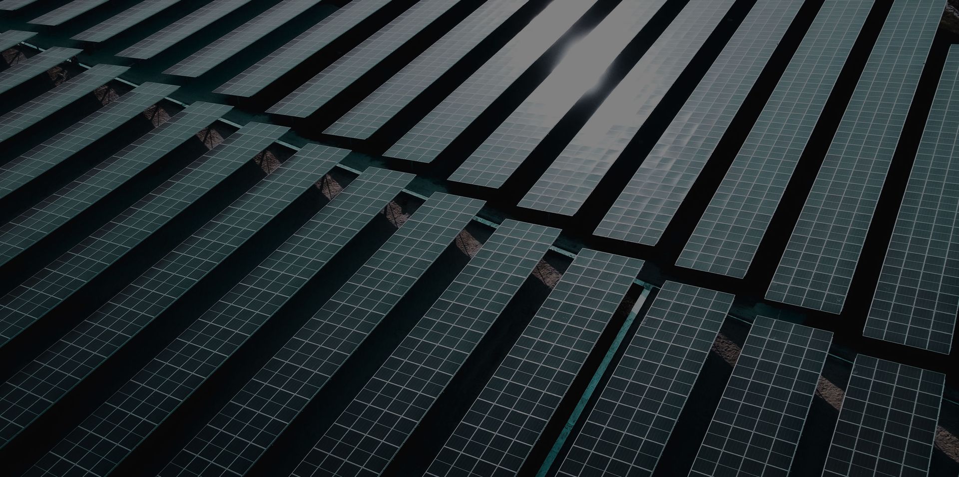 Large-scale solar panel array at an industrial energy facility